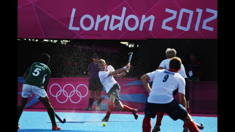 Britain's James Tindall, center, makes a move during the men's field hockey match between Britain and Pakistan.