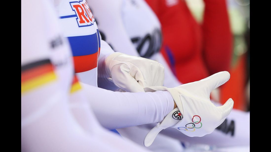 Russia's Ekaterina Gnidenko puts on her gloves as she prepares to compete in the women's cycling-track keirin qualifying event.