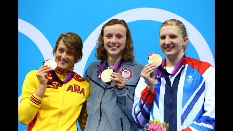Left to right: Silver medallist Mireia Belmonte Garcia of Spain, gold medalist Katie Ledecky of the United States and bronze medalist Rebecca Adlington of Great Britain on the podium during the medal ceremony for the women's 800-meter freestyle final on day 7 of the London 2012 Olympic Games.