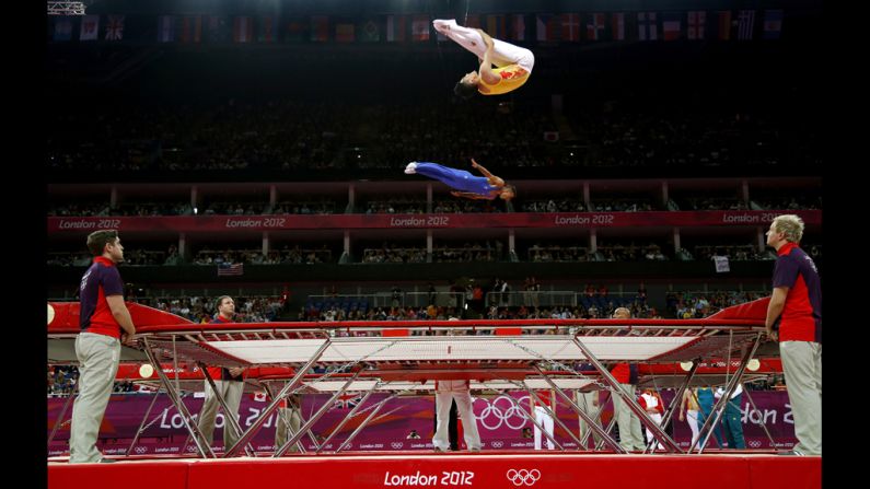 Italy's Flavio Cannone, center, and China's Dong Dong, up, train before the men's trampoline final of the artistic gymnastics event on Friday.