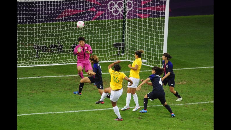 Renata Costa of Brazil blasts a shot over the bar as goalkeeper Miho Fukumoto of Japan looks on during the women's football quarter final match between Brazil and Japan on Friday.