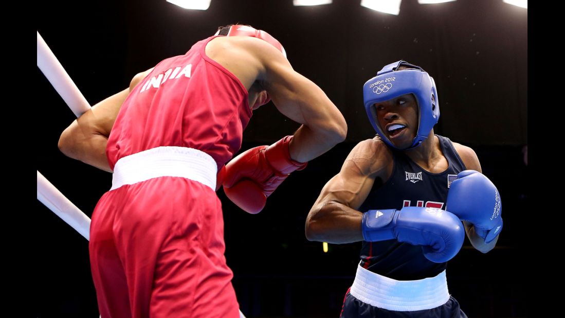 Krishan Vikas of India, left, in action with Errol Spence of United States, right, during the men's welter (69 kilogram) boxing match.