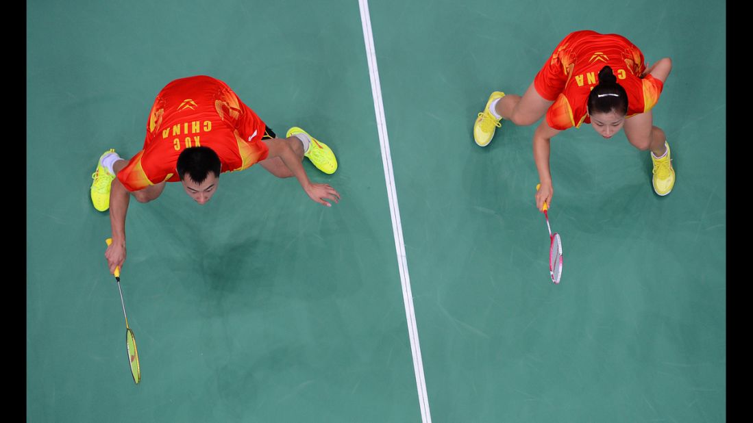 China's Xu Chen, left, and Ma Jin, right, play against China's Zhang Nan and Zhao Yunlei (not pictured) during the mixed doubles gold medal match.
