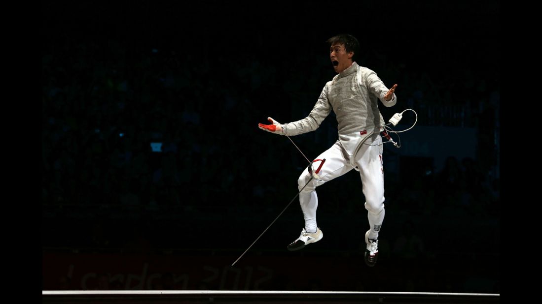 Woo Young Won of South Korea celebrates after defeating Romania to win the gold medal in the men's sabre team fencing.