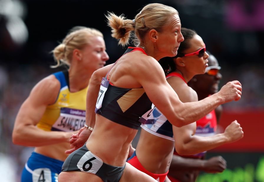 Jennifer Oeser of Germany competes in the women's heptathlon 100-meter hurdles heat.