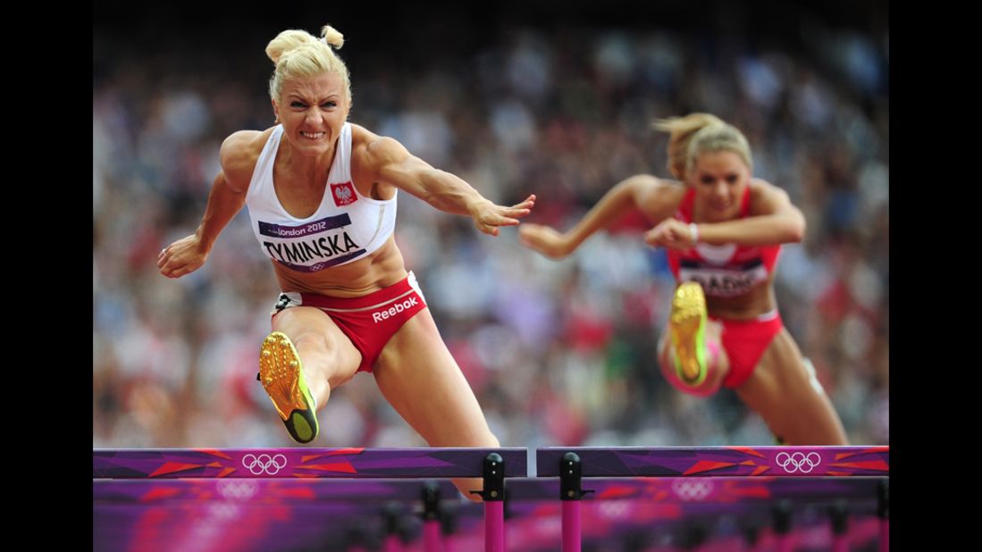Poland's Karolina Tyminska, left, competes in the women's heptathlon 100-meter hurdles heat.