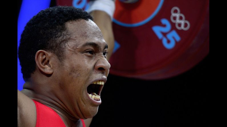 Papua New Guinea's Steven Kari gestures while competing during the men's 85-kilogram weightlifting event.