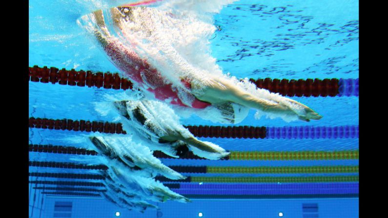 Jolien Sysmans of Belgium dives into the water at the start of the women's 50-meter freestyle heat.