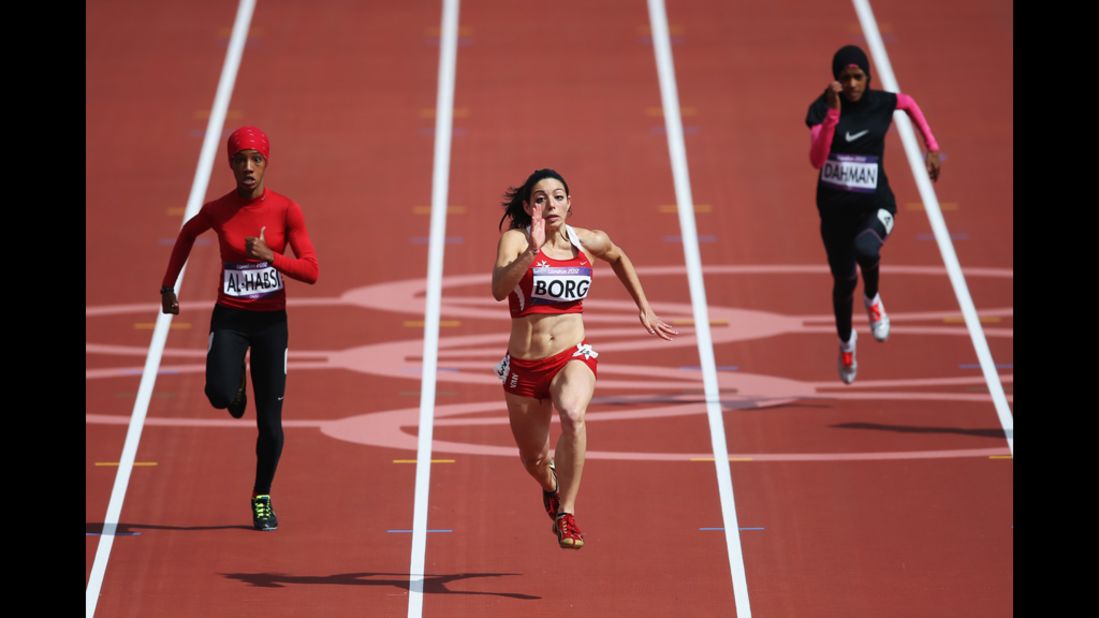 Oman's Shinoona Salah Al-Habsi, left, and Diane Borg of Malta compete in the women's 100-meter heats. Check out photos from <a href="http://www.cnn.com/2012/08/04/worldsport/gallery/olympics-day-8/index.html" target="_blank">Day 8 of the competition </a>on Saturday, August 4.