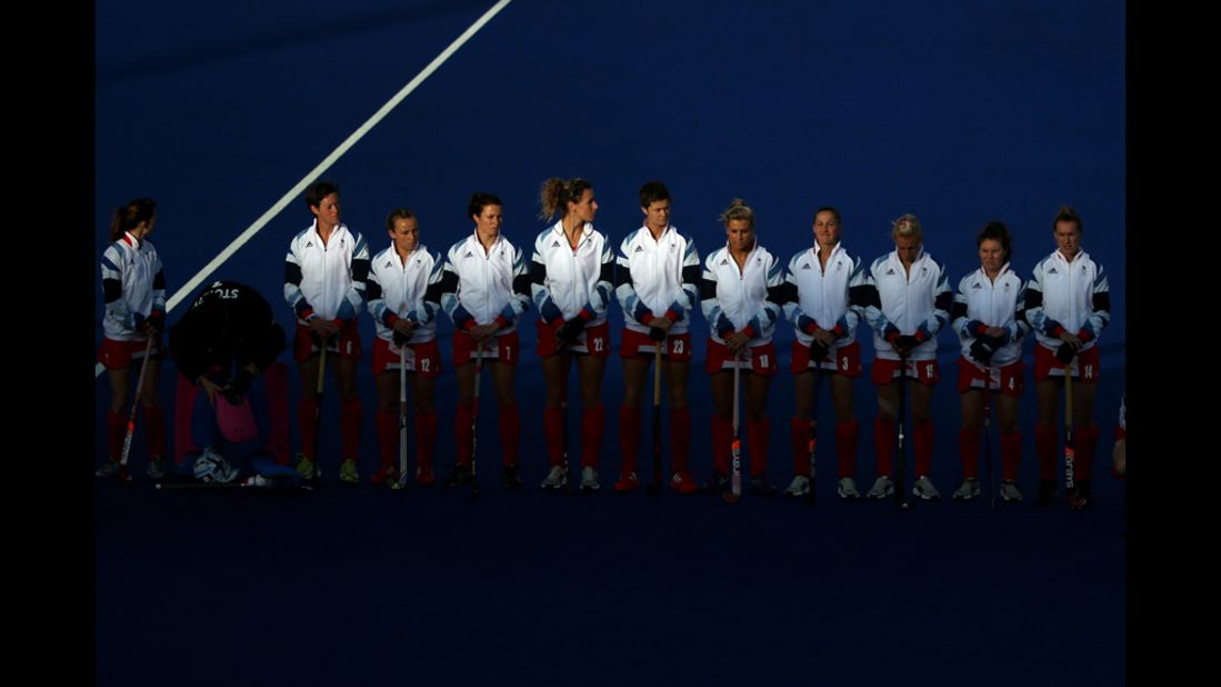 The Great Britain hockey team lines up for the national anthem ahead of their preliminary match against Belgium.
