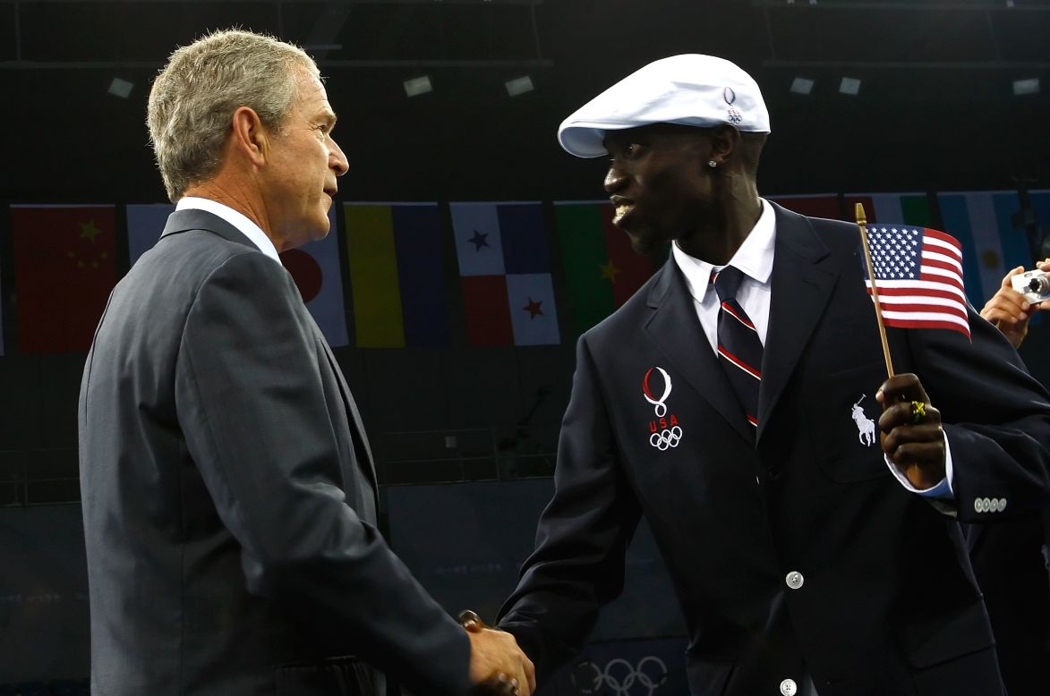 Former U.S. President George W. Bush greets Lomong on the opening day of the Beijing 2008 Olympic Games.