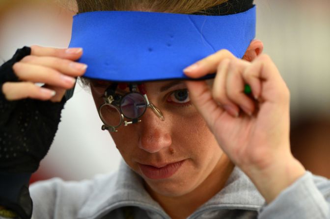 Gray adjusts her shooting equipment during the women's 50-meter rifle 3 positions shooting qualification.
