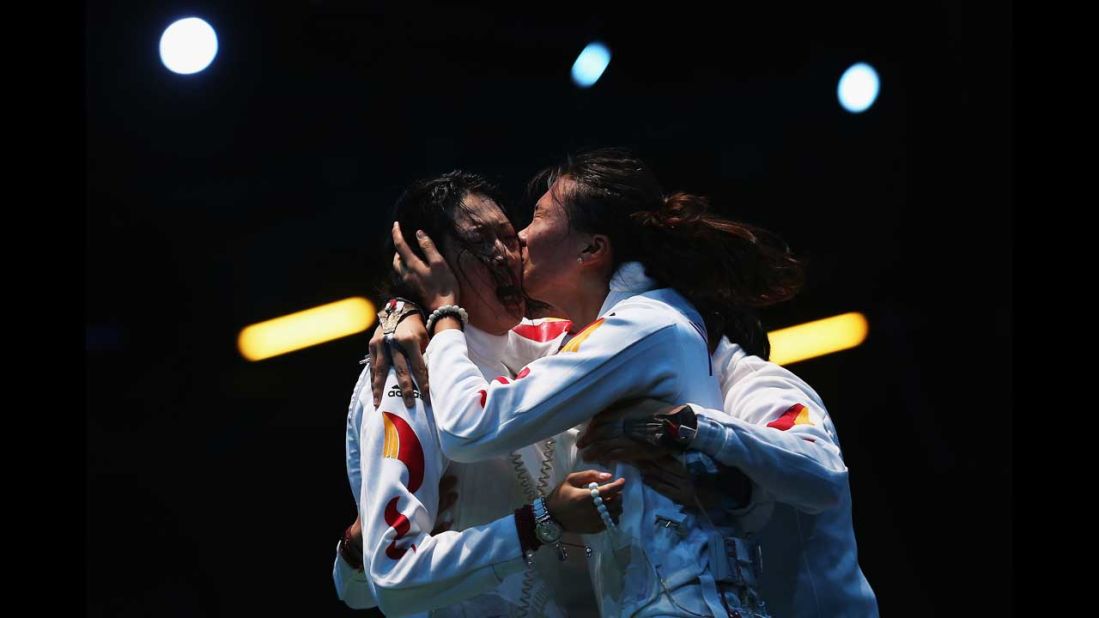Sun Yujie and Xu Anqi of China celebrate after China beat Russia in the women's epee team fencing semifinal.