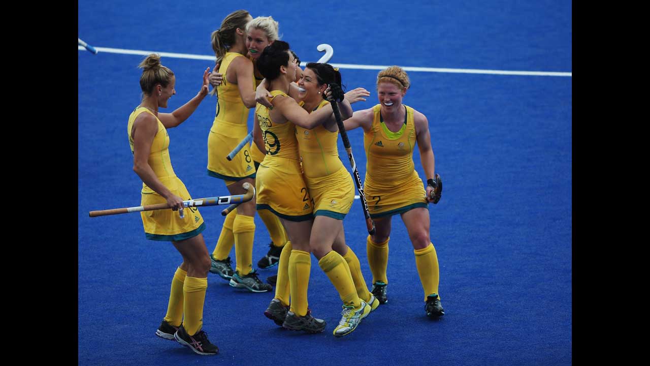 The Australian women's hockey team celebrates during a preliminary round group B match against South Africa.