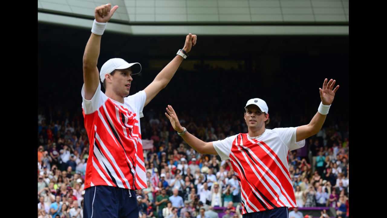 Mike Bryan, left, and Bob Bryan celebrate after defeating France's Michael Llodra and Jo-Wilfried Tsonga to win gold in the men's doubles event.