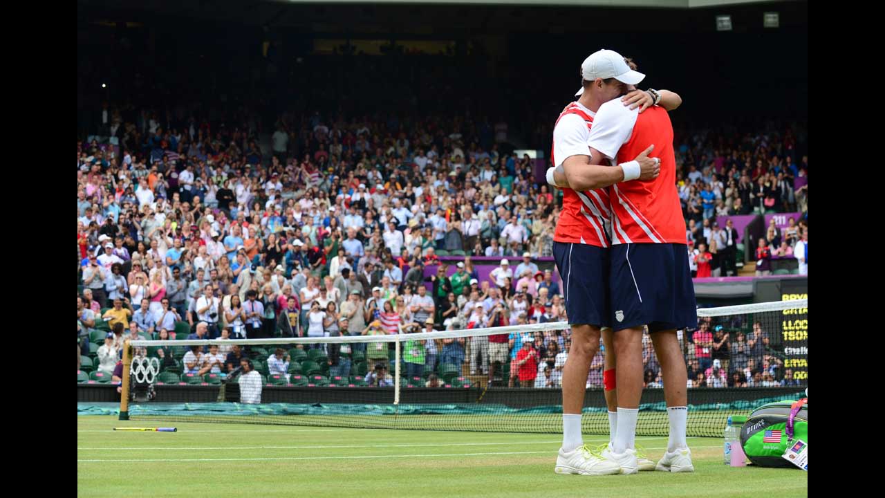 Brothers Mike Bryan, left, and Bob Bryan embrace after defeating France's Michael Llodra and Jo-Wilfried Tsonga in the men's doubles gold medal tennis match on Saturday, August 4, at Wimbledon.