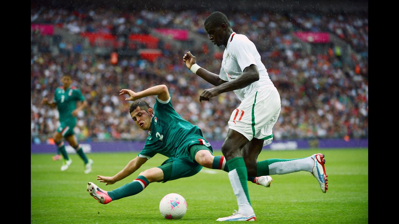Mexican defender Israel Jimenez, left, challenges Senegalese forward Kalidou Yero in a men's football quarterfinal match at Wembley Stadium in London.