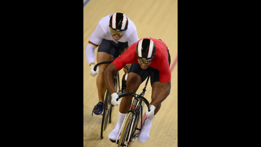 Robert Forstemann of Germany, left, competes against Njisane Nicholas Phillip of Trinidad and Tobago during the men's sprint round-of-eight cycling event.