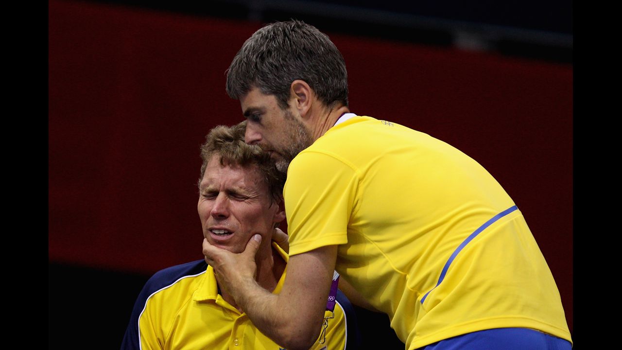 A teammate urges Jorgen Persson, left, of Sweden to focus during a table tennis match.