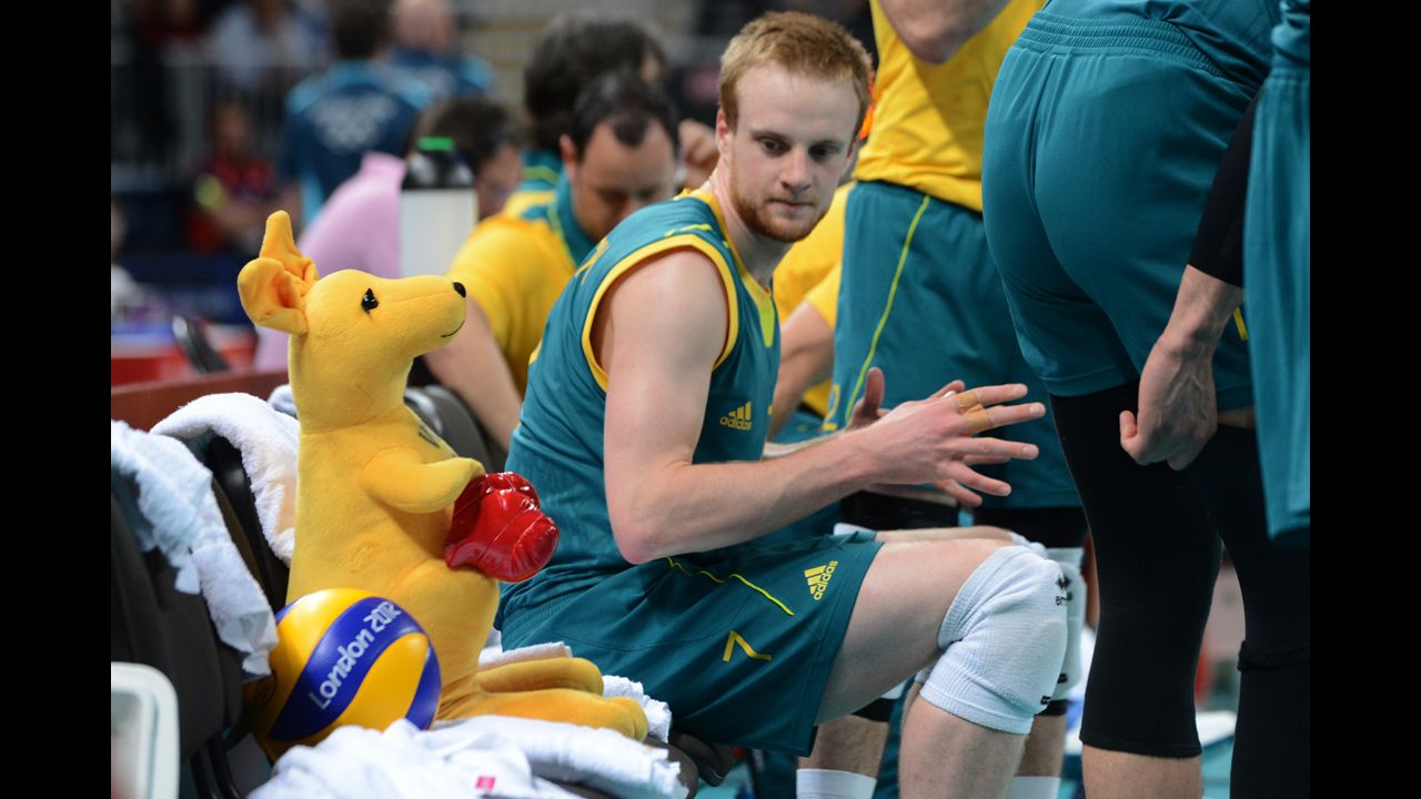 Australia's Harrison Peacock listens to his coach during a volleyball match.