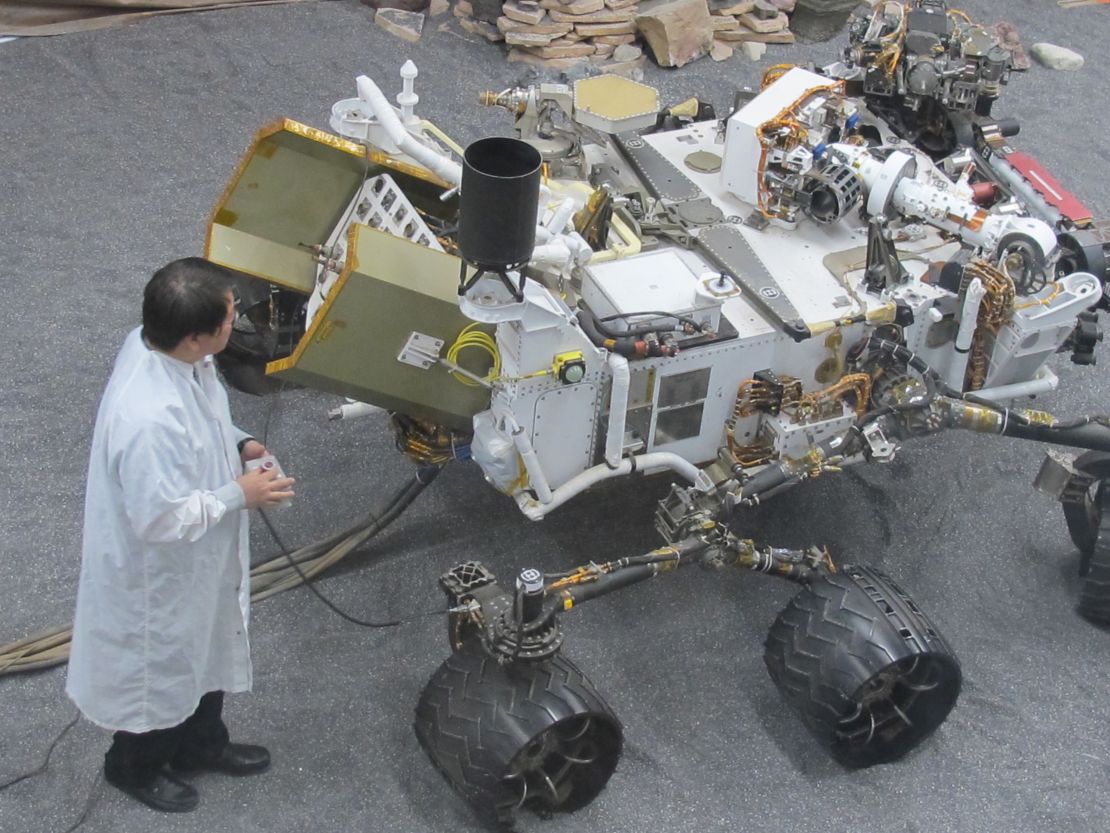 James Wang, test conductor for Curiosity, with the test model of the rover used for experiments on Earth.