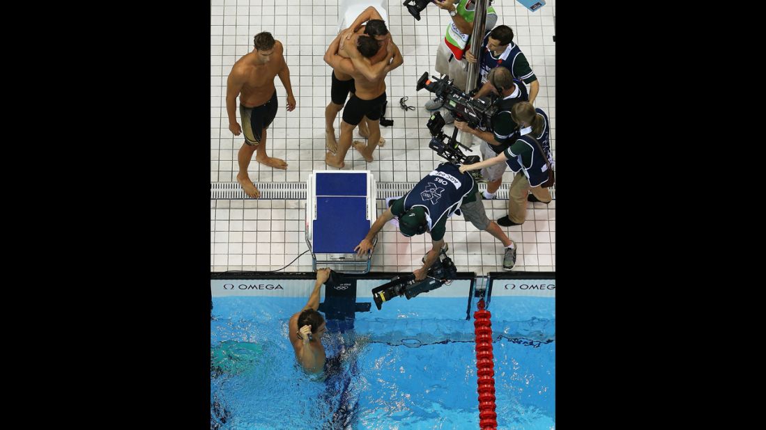 Clockwise: Matthew Grevers, Brendan Hansen, Michael Phelps and Nathan Adrian react to winning gold in the men's 4x100-meter medley relay.