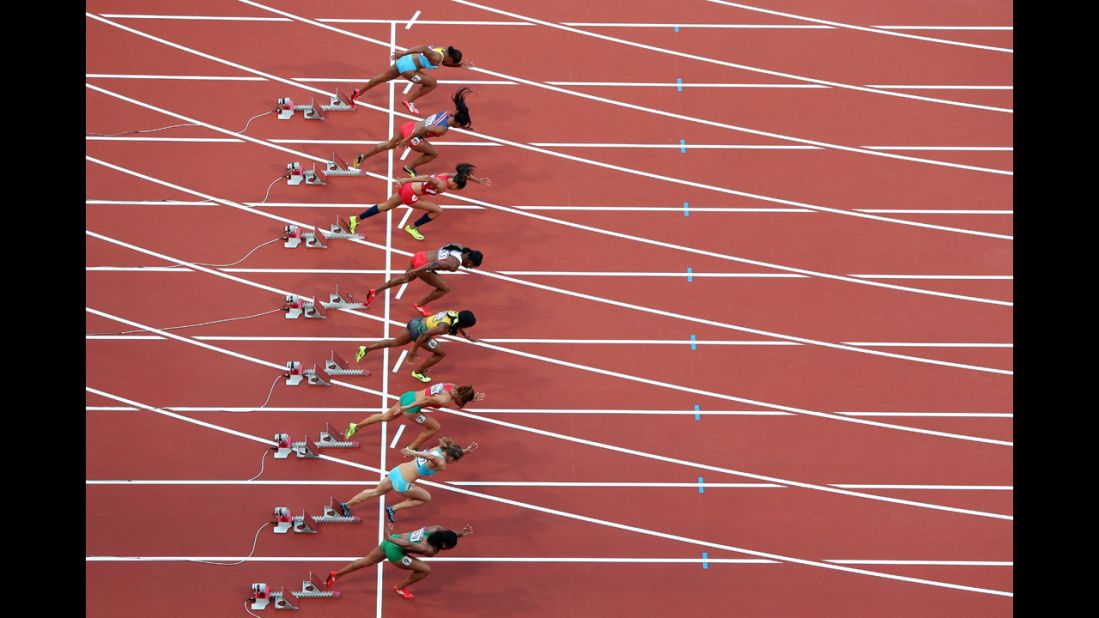 Athletes start in the women's 100-meter semifinal at Olympic Stadium.
