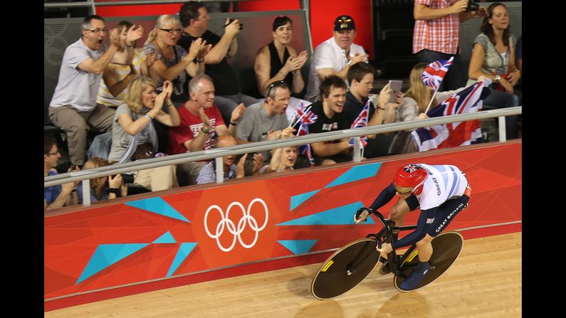 Jason Kenny of Great Britain is cheered on by spectators as he sets a new Olympic record during the men's sprint track cycling qualifying event. 