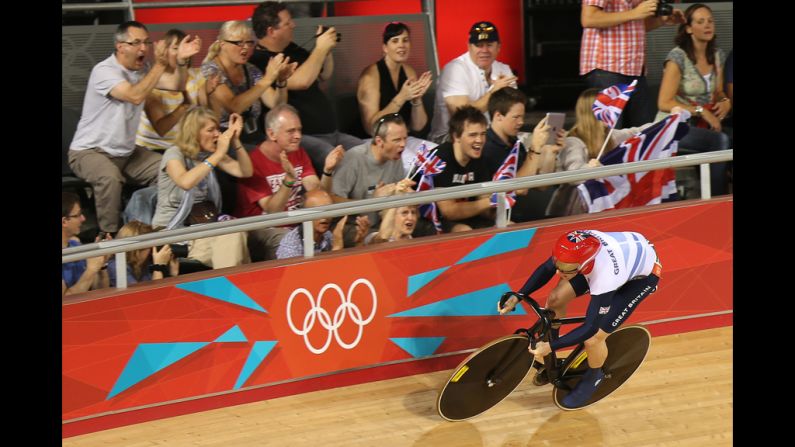 Jason Kenny of Great Britain is cheered on by spectators as he sets a new Olympic record during the men's sprint track cycling qualifying event.