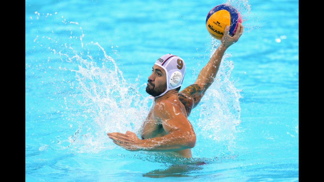 Nikola Raden of Serbia takes a shot at goal during a men's preliminary round water polo match against the United States.