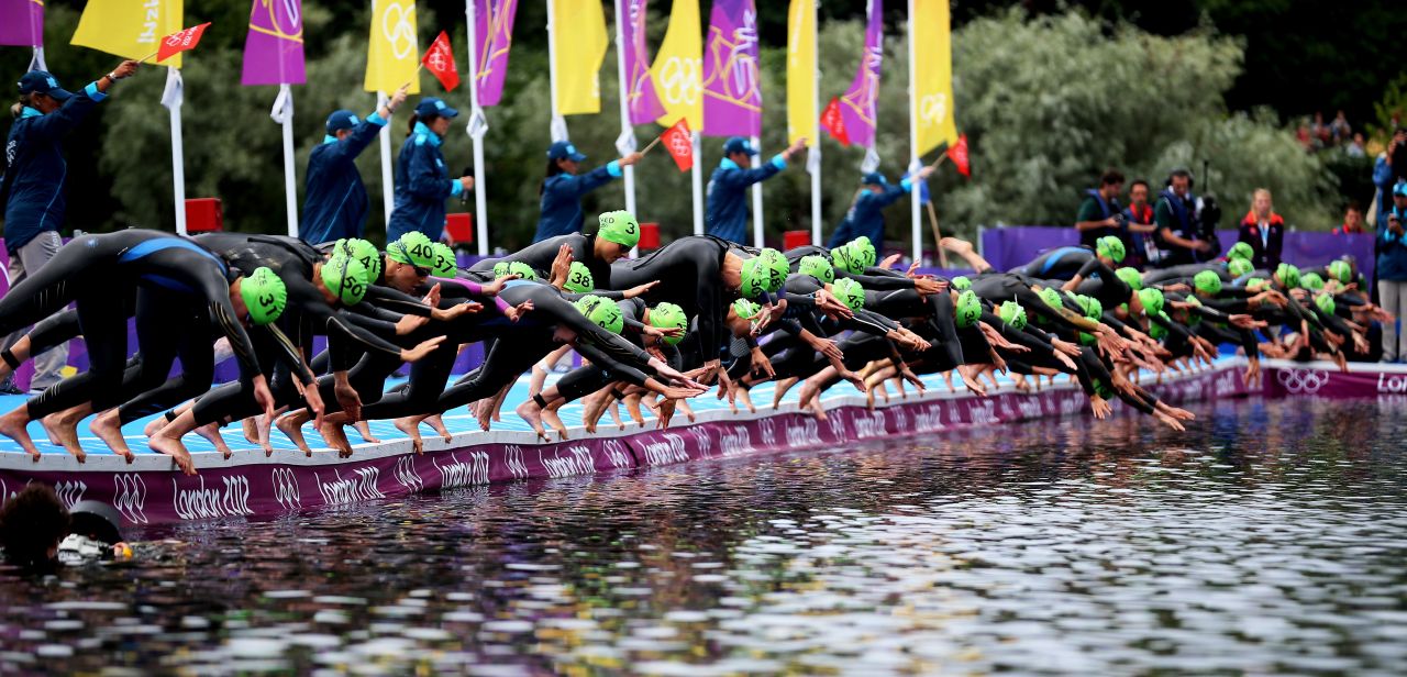 Athletes dive into the water at the start of the women's triathlon at Hyde Park.