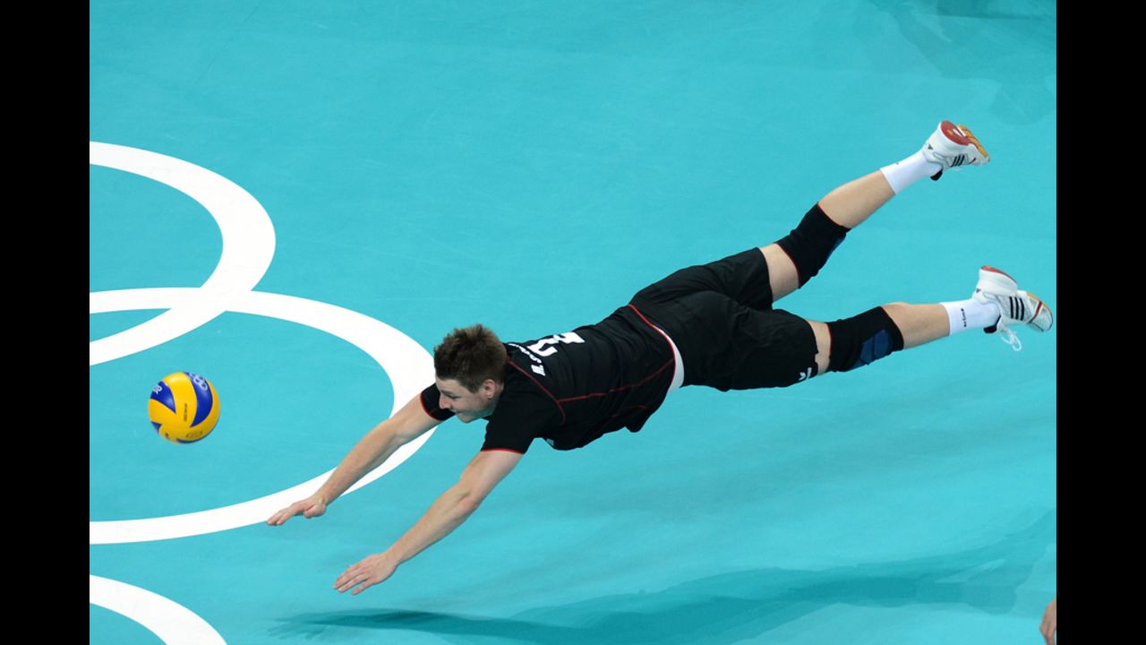 Germany's Markus Steuerwald dives for the ball during the men's preliminary volleyball match between Germany and Tunisia.
