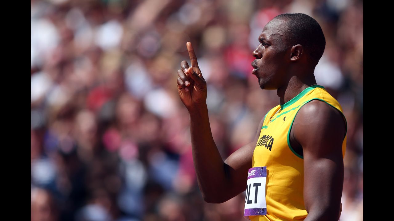 Usain Bolt of Jamaica signals a No. 1 after competing in the men's 400-meter round 1 heat.
