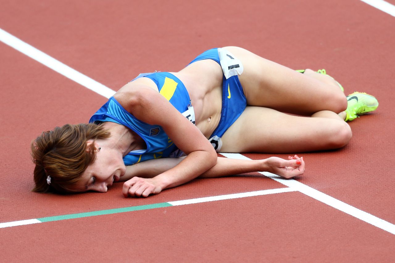 Valentyna Horpynych Zhudina of Ukraine lies on the track after competing in the women's 3000-meter steeplechase.