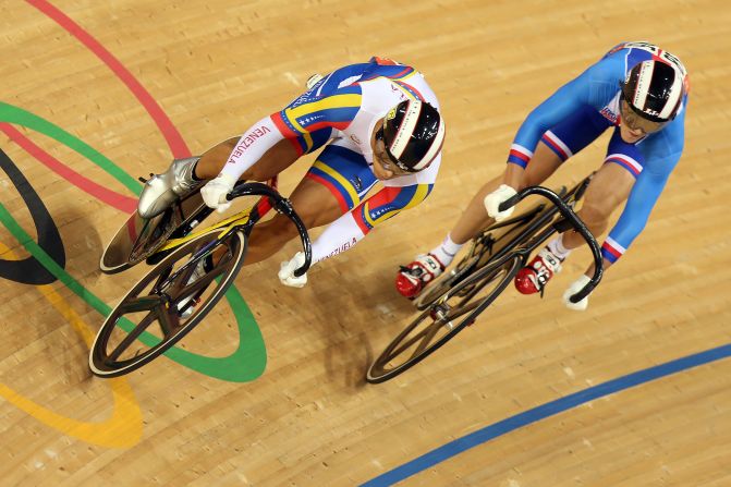 Hersony Canelon of Venezuela, left, races against Pavel Kelemen of Czech Republic during the men's sprint track cycling 1/16 finals.