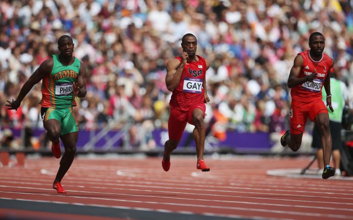 Gerald Phiri, left, of Zambia, Tyson Gay, center, of the United States and Richard Thompson of Trinidad and Tobago compete in the Men's 100-meter Round 1 Heats.