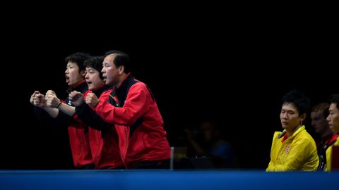 Japan's table tennis team celebrates a point for Koki Niwa against Hong Kong's Peng Tang during a men's quarterfinal match.