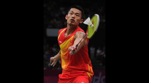 Lin Dan of China strikes the shuttlecock on his way to winning the men's singles gold medal against Chong Wei Lee of Malaysia.