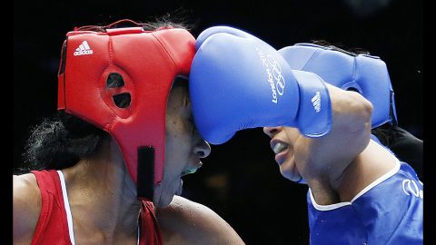 Erika Matos, left, of Brazil takes a punch from Karlha Magliocco of Venezuela in a women's flyweight boxing round of 16 match.