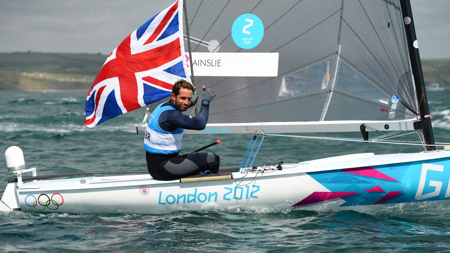 Britain's Ben Ainslie celebrates after winning his fourth successive gold medal in the Finn class