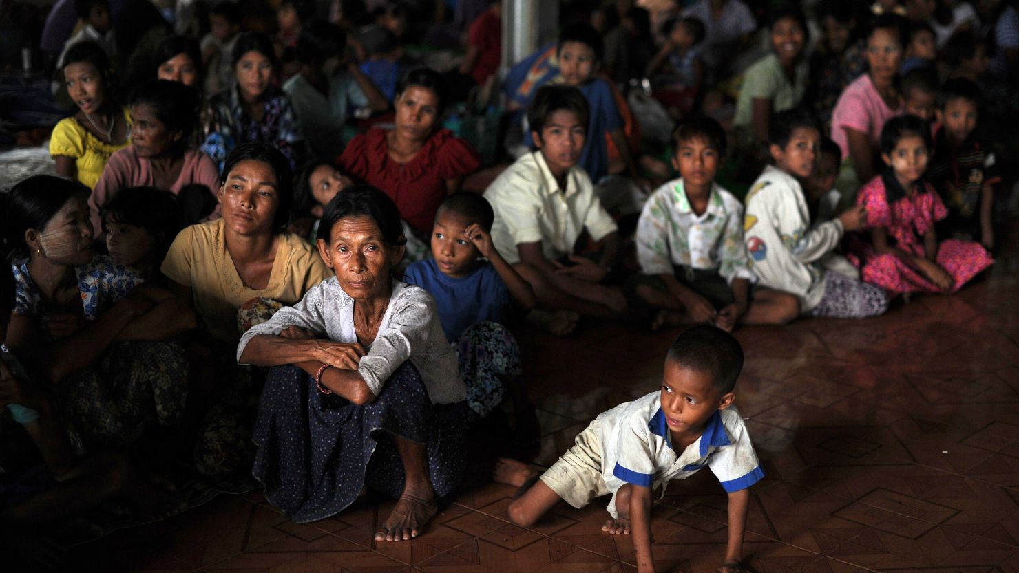 People displaced by sectarian violence sit at a monastery used as a temporary shelter in Sittwe, Myanmar.
