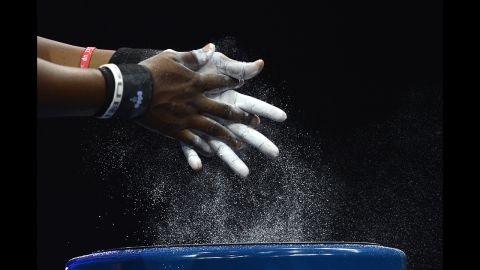 Ghana's Alberta Boatema Ampomah prepares her hands before competing in the women's 75-plus kilogram group A weightlifting event.