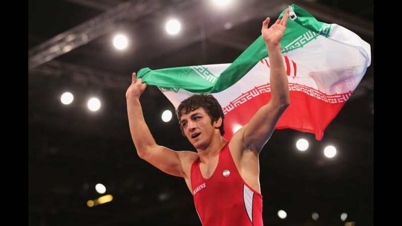 Hamid Mohammad Soryan Reihanpour of Iran celebrates winning the gold medal in the men's Greco-Roman 55 kilogram wrestling bout.