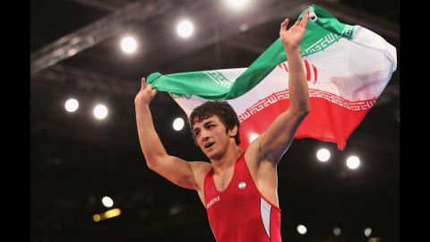 Hamid Mohammad Soryan Reihanpour of Iran celebrates winning the gold medal in the men's Greco-Roman 55 kilogram wrestling bout.