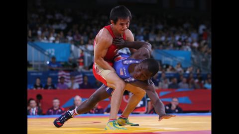 Mingiyan Semenov, left, of Russia grapples with Spenser Thomas Mango of the United States during the men's Greco-Roman 55-kilogram wrestling qualification matches.
