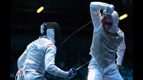Marcel Marcilloux of France strikes Richard Kruse of Great Britain during the men's foil team fencing match.