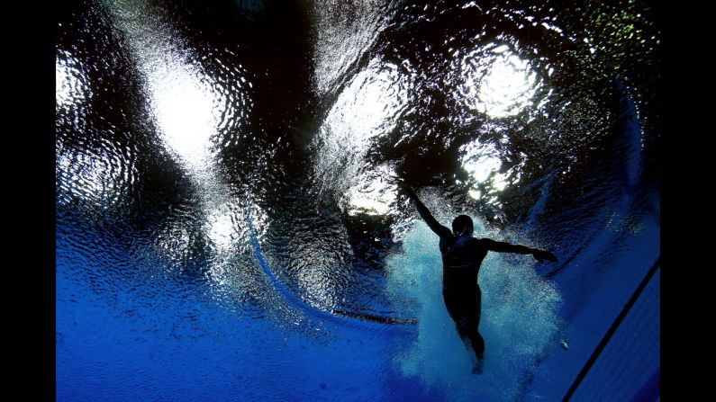 Cassidy Krug of the United States swims after her dive in the women's 3-meter springboard diving final.