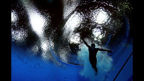 Cassidy Krug of the United States swims after her dive in the women's 3-meter springboard diving final.