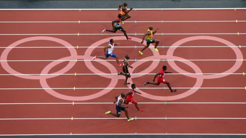 Asafa Powell of Jamaica and Justin Gatlin of the United States lead the pack in the men's 100-meter semifinal.