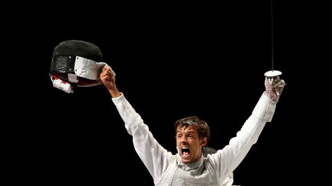 Andrea Baldini of Italy is joyous after defeating Kenta Chida of Japan to win the gold medal in the men's foil team fencing.